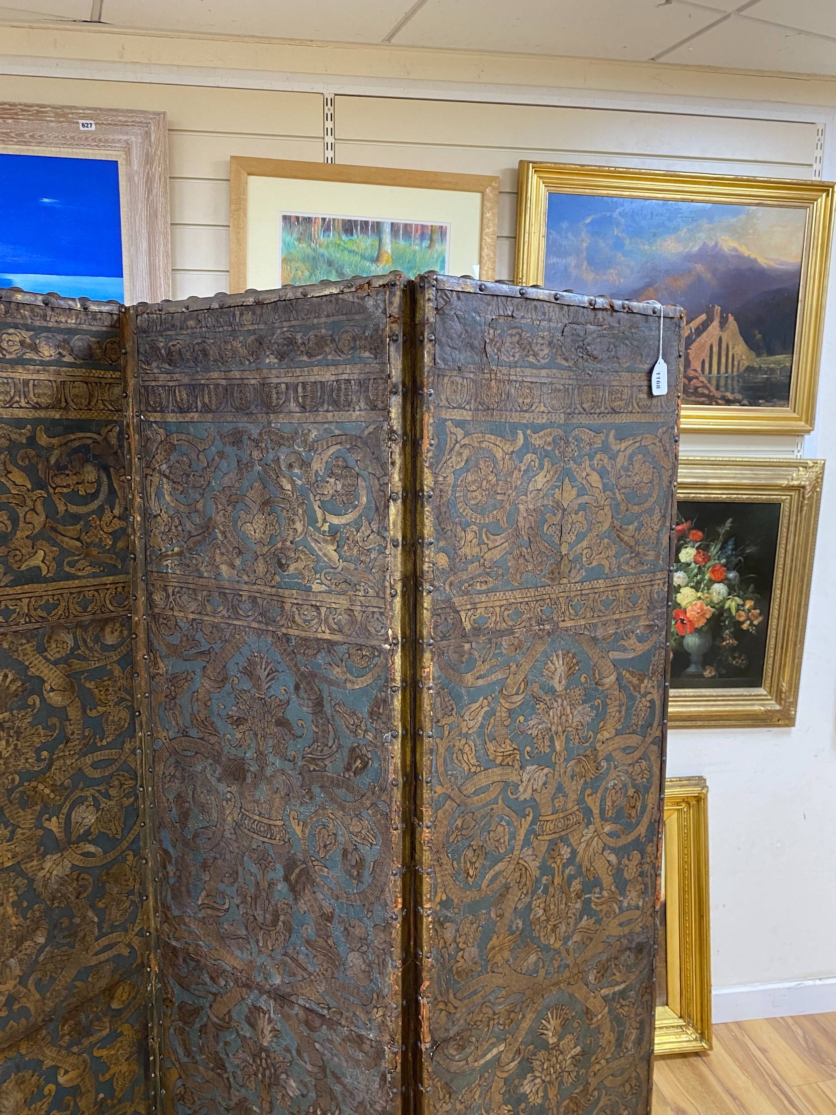 A 19th century French studded leather four fold screen, each panel width 49cm, height 182cm
